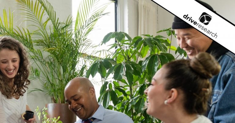 People laughing in group near plants