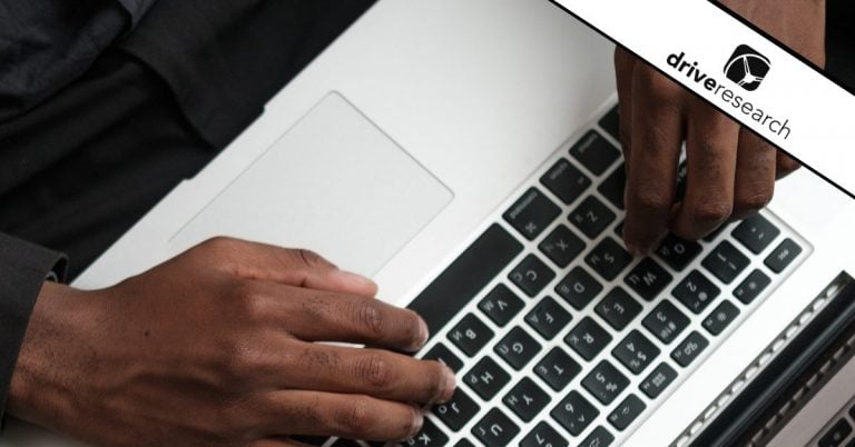 Black male hands typing on laptop - drive research