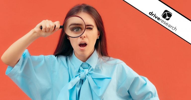 Female looking through a magnifying glass