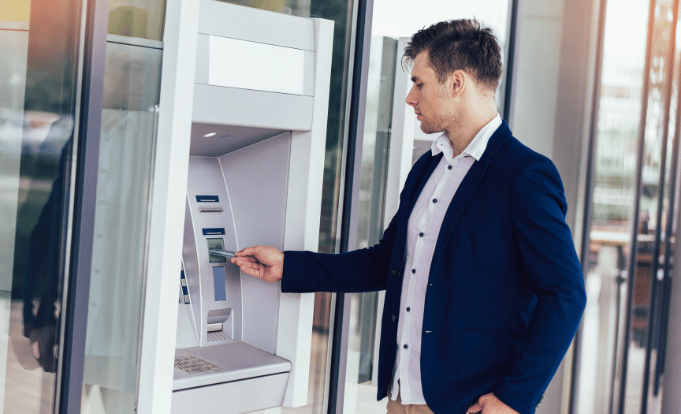 Man using credit union atm