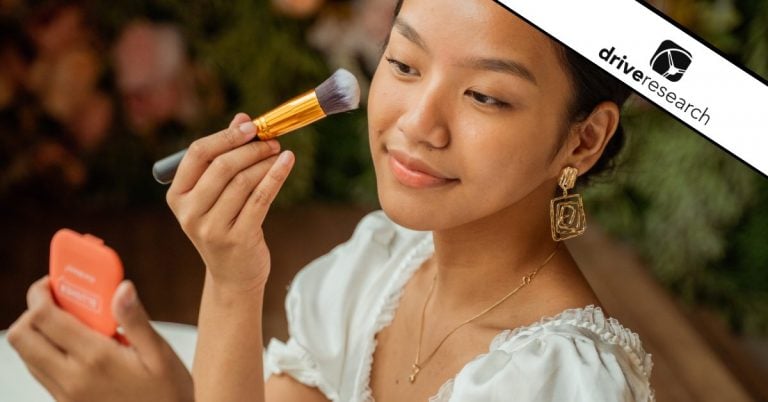 Woman applying face makeup with a brush