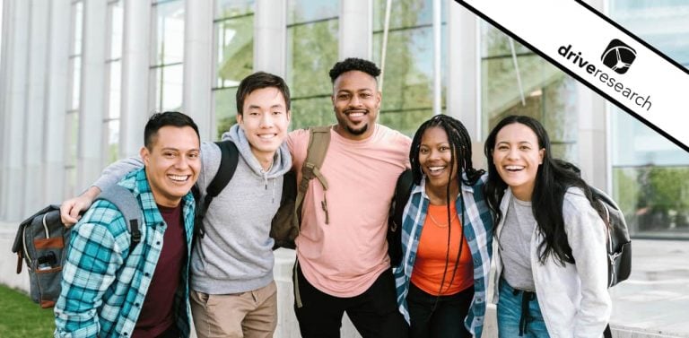 College students smiling outside of building