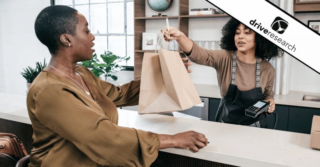 Woman handing customer bag