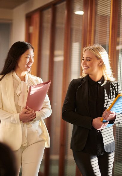 Two female lawyers walking in office