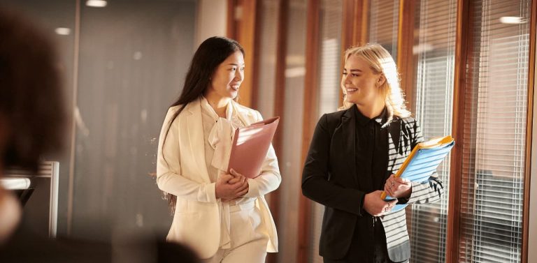 Two female personal injury lawyers walking in the office