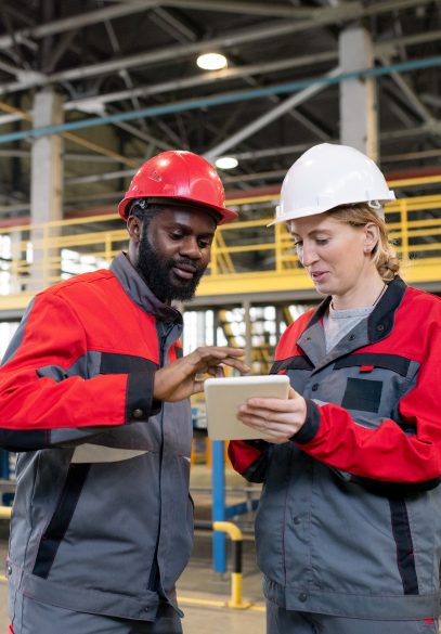 Two manufacturing workers discussing issues