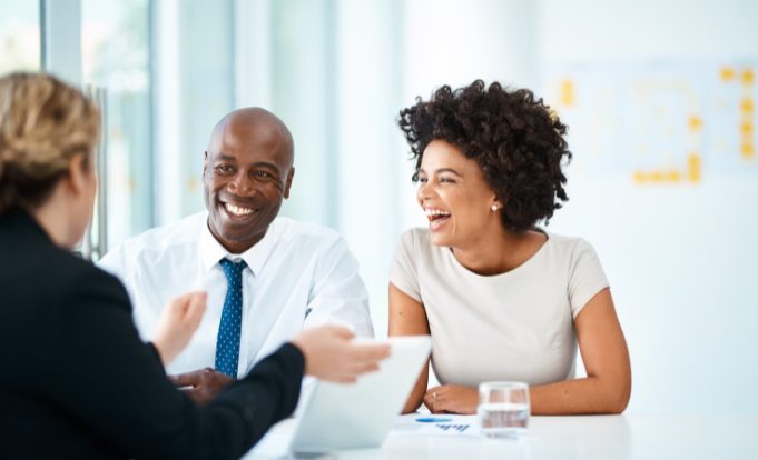 Male and female business people laughing