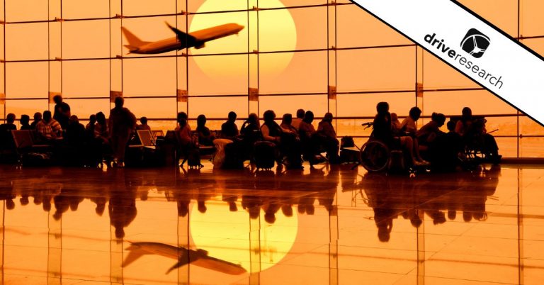 Travelers waiting at gate in airport.