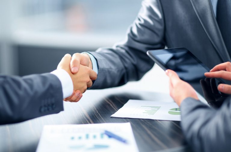 Two men shaking hands at bank