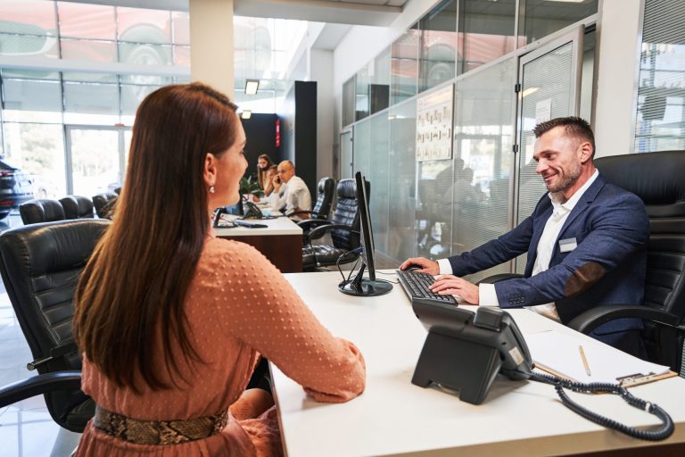 Friendly bank manager spending time with female customer