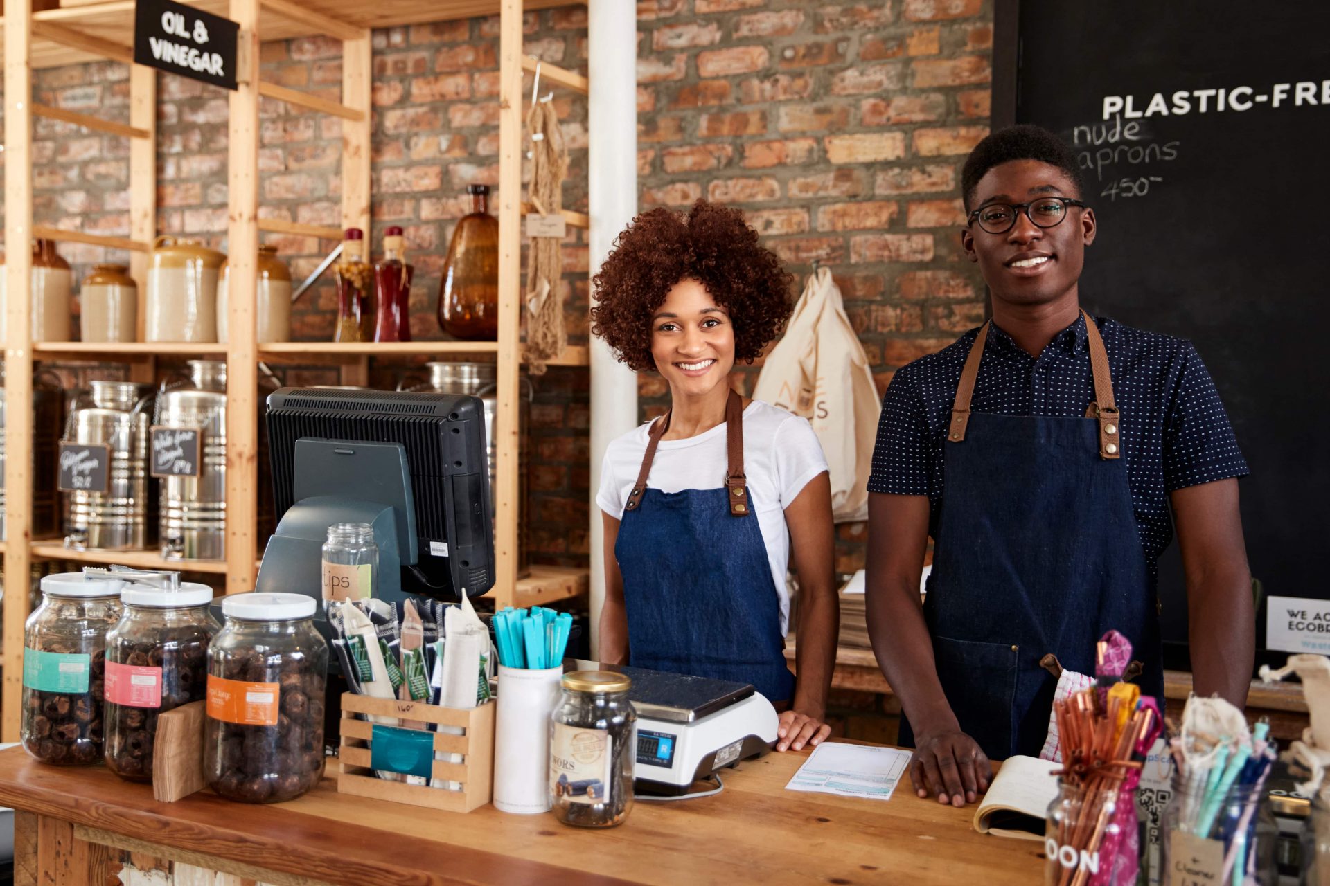 Portrait Of Male And Female Owners Of Sustainable Plastic Free Grocery Store