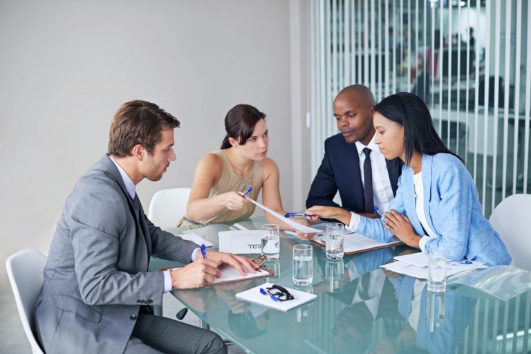 Shot of a group of lawyers going over documents during a meeting