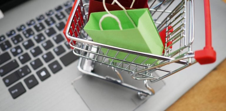 Shopping cart figurine on laptop