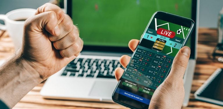 Man making sports bets on his phone