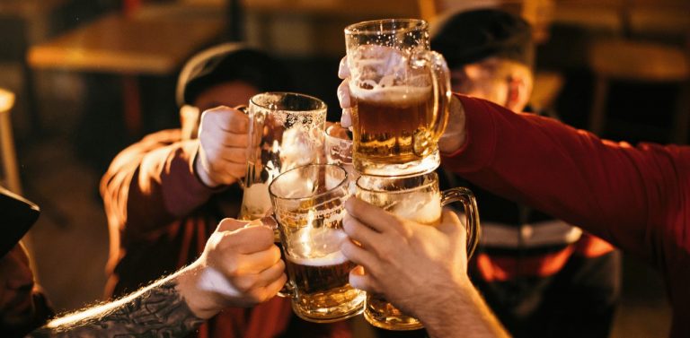 Men cheering with pints of beer