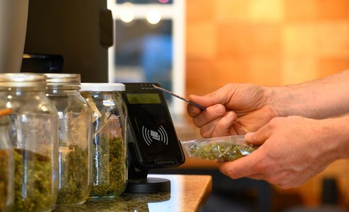 Person purchasing cannabis with credit card