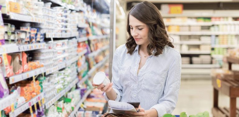 Young woman grocery shops for dairy items