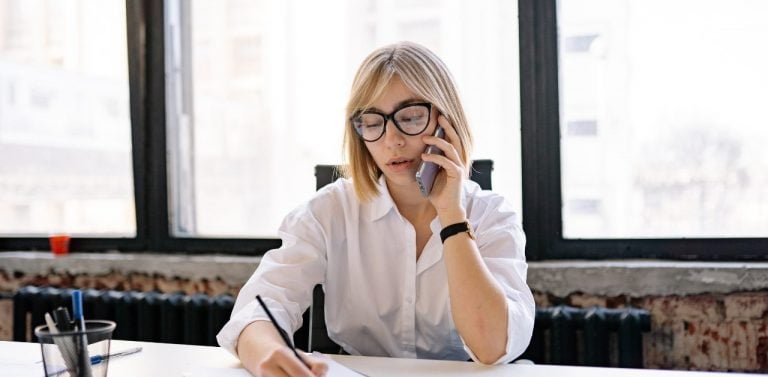 Woman talking on phone in office